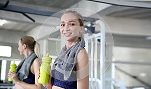 Sporty young woman drinking water at gym. Female drink water. B