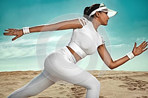 Sporty young woman and fit athlete runner running on the sky background. The concept of a healthy lifestyle and sport