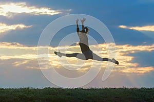 Sporty young woman jumping outdoor morning clouds background, Athlete Woman jump beautiful sunrise morning workout