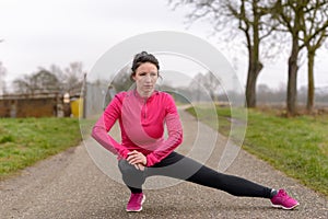 Sporty young woman limbering up