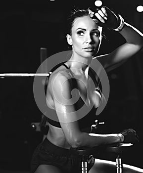 Sporty young woman working out with dumbbells weight in Gym. Diet and weight loss concept