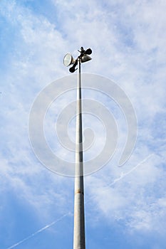 Spot light pole on blue sky and clouds.