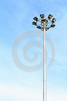 Spot-light tower at the road on blue sky