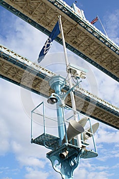 Spot lights, a public loudspeaker, flags, & CCTV camera on The Tower Bridge, London, England