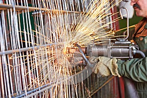 Spot welding. industrial factory worker making reinforcement grid