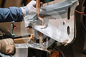 Spot welding machine Industrial automotive part in factory. Operator working in industry.