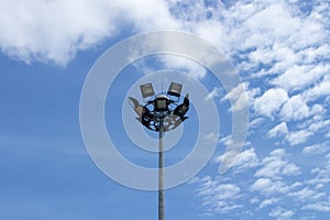 Spotlight pole in sport field with blue sky background