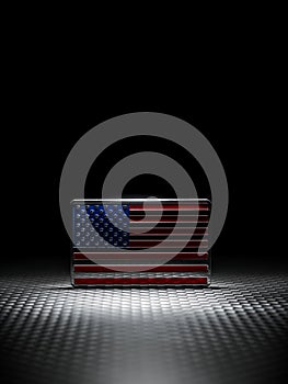 Spotlight on shiny US American flag emblem on carbon fiber. Symbolizing USA strength, Memorial day, Veteran\'s day