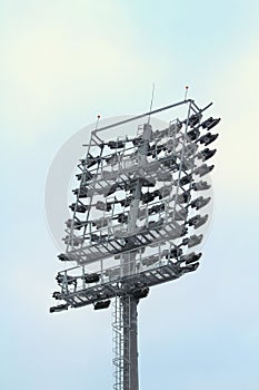 Spotlight on a sports stadium on blue sky background, daylight