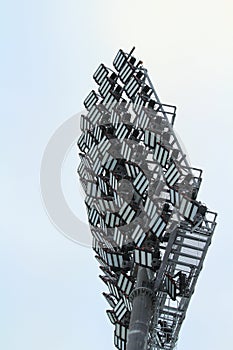 Spotlight on a sports stadium on blue sky background, daylight