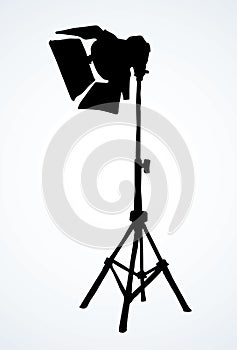 Spotlight on a stand. Vector drawing