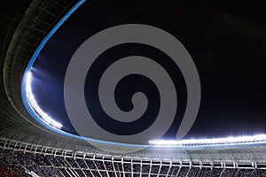 Spotlights and floodlights at a stadium at night photo