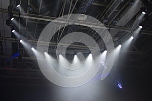 Spotlights. The stage for the performance is illuminated by floodlights. A ray of light breaks through the smoke.Lighting equipmen