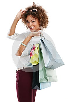 Spotting a sale is just one of my skills. Studio portrait of an attractive young woman holding shopping bags against a