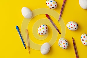 Spotty painted colorful easter eggs on yellow background