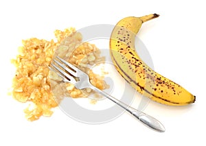 Spotty ripe banana with mashed flesh and fork