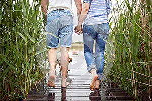 Spouses barefoot enjoy an after rain weather on the dock