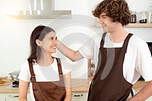 Spouses enjoy warm conversation and cooking process
