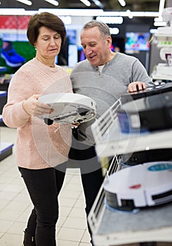 Spouses of mature age attentive choose a robot vacuum cleaner