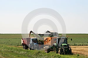 Spouting corn combine harvester photo