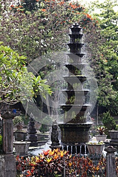 Spouting Fountain with sparkling drops in Bali water palace gardens of Tirtagangga