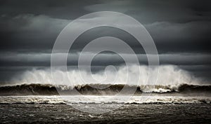 Spray being blown from big waves on a cloudy day