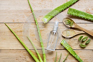 Spray bottle with aloe vera leaves on the table