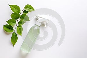 Spray bottle with cleaning product and green leaves around. Eco cleaning concept. Environmentally friendly bio natural cleaning