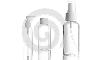 Spray bottle, empty pump clear plastic container cosmetic soap and mineral shampoo. Antiseptic gel isolated in water