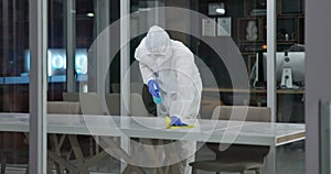 Spray, disinfect and person with hazmat suit in laboratory for germs, virus exposure or prevent infection. Biohazard