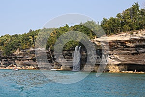 Spray falls, colorful sandstone cliffs and formations at Pictured Rocks National Lakeshore of Lake Superior, Munising, Michigan