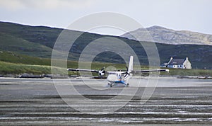 Spray Flying from a Plane Landing at the Barra Airport