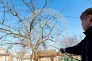 Spray garden. Fumigating pesti, pest control. Defocus farmer woman spraying tree with manual pesticide sprayer against