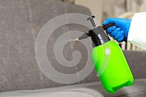 Spray gun with pesticides close-up. Fight against insects in apartments and houses. Disinsection of premises