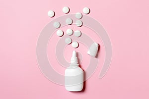 Spray for nose congestion treatment on pink background - cold, flu and medicine concept