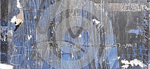 Spray paint of black paint on a blue metal surface, painted worn metal texture background, worn out metal, background material