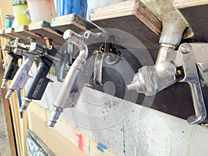 Spray pistoles for varnishing in a painters shop garage are ideal for automobile airbrushing with a compressor to repair cars