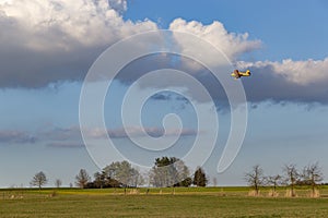 A spray plane applies chemicals to a field. Agricultural aviation