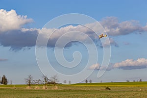 A spray plane applies chemicals to a field. Agricultural aviation