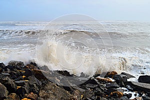 Spray of Water Drops with Hitting of Sea Wave to Rocks on Shore - Ocean Natural Aqua Background