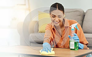 Spray, woman and smile for cleaning table, furniture and housekeeping services at home. Female cleaner wipe surface with