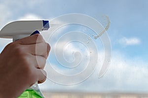 The sprayer disperses window cleaner onto the surface of dirty glass