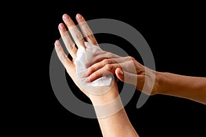 Spraying antiseptics on hands for disinfection on a black background