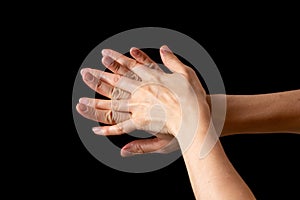 Spraying antiseptics on hands for disinfection on a black background