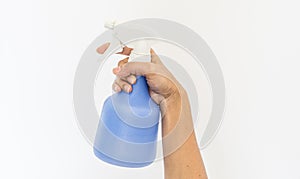 Spraying a cloth with laundry detergent in spray bottle on hand