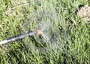 Spraying herbicide from the nozzle of the sprayer manual