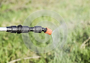 Spraying herbicide from the nozzle of the sprayer manual