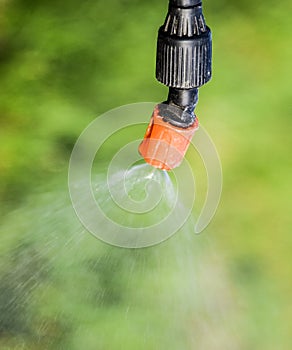 Spraying herbicide from the nozzle of the sprayer manual