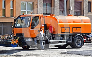 Spraying lorries at the road construction