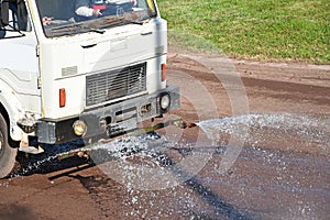 Spraying lorries at work on the dirty sport track